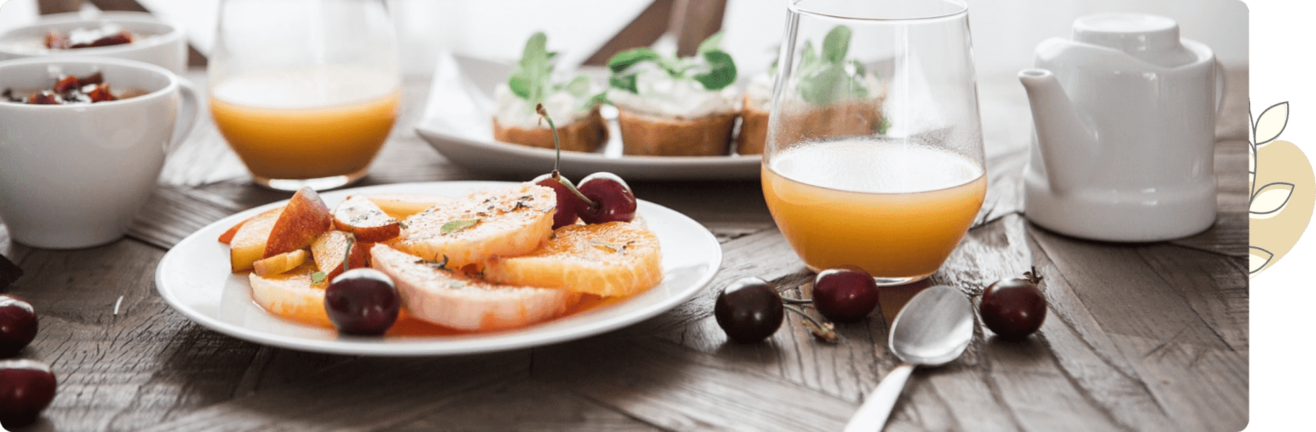 A table with plates of food and glasses on it