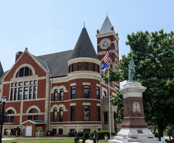 A large building with a clock tower in the background.